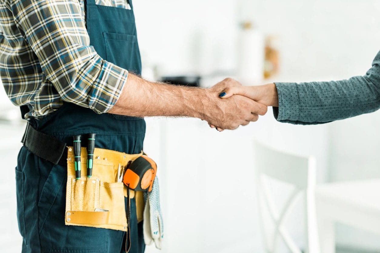 Two men shaking hands in a room.